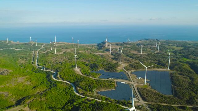 Wind turbines for electric power production on the seashore. Ecological landscape. Aerial view of solar power station.
