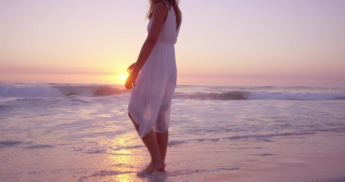 Travel, walk or woman at ocean with thinking, sunset or peaceful mindset on beach vacation. Stroll, water splash or tourist outdoor with getaway, calm perspective or summer evening on holiday break.