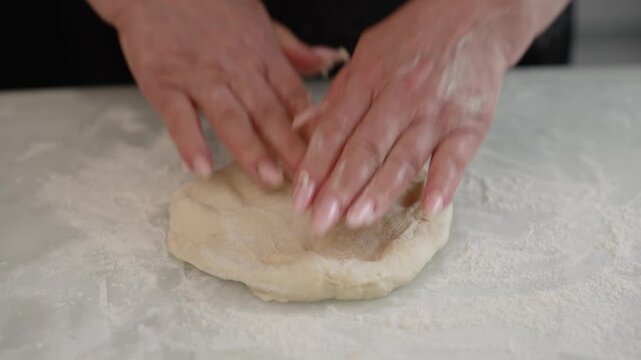 Baker kneading and shaping dough for baking