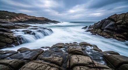 Fototapeta premium Ocean waves crash on rocky coastline