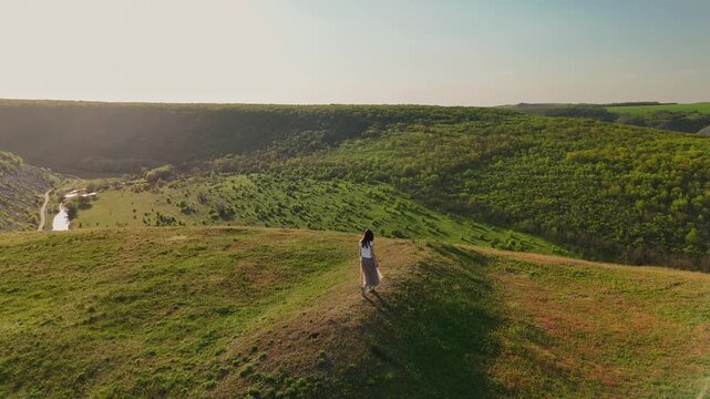 Person Standing At Cliff Lookout Facing Sweeping Valley And River, Calm Sunrise Glow, Reflective Stance, Wide