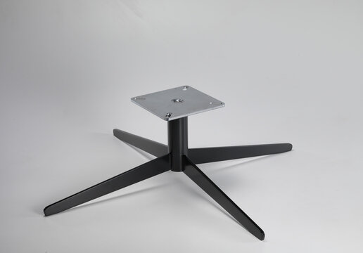 Still life of the iron base of a table, on a neutral background