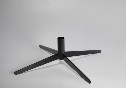 Still life of the iron base of a table, on a neutral background