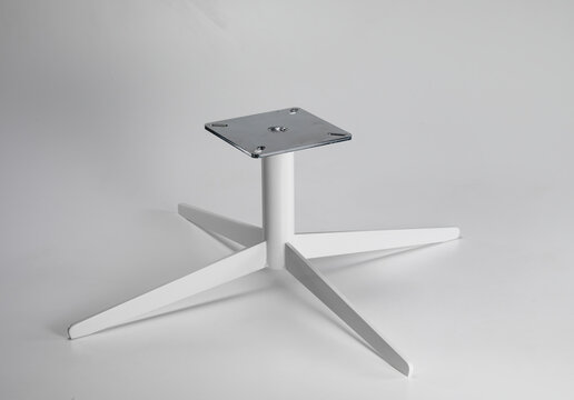 Still life of the iron base of a table, on a neutral background