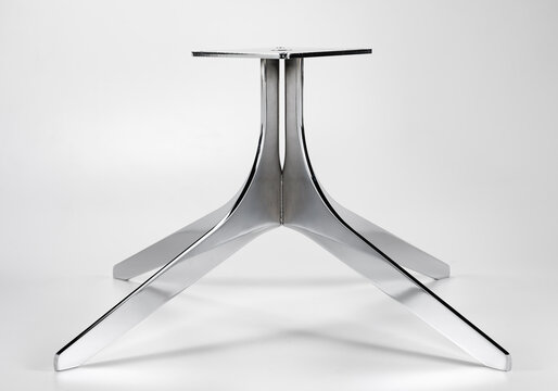 Still life of the iron base of a table, on a neutral background
