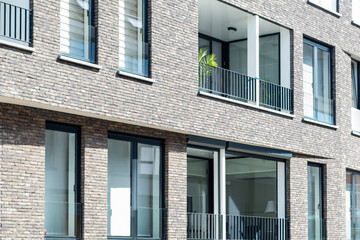 Modern Residential Building with Grey Brick Facade and Balconies,New Apartment Block Architecture with Minimalist Brickwork,Newly Built Apartment House in a Modern City District © Anna Kondratiuk