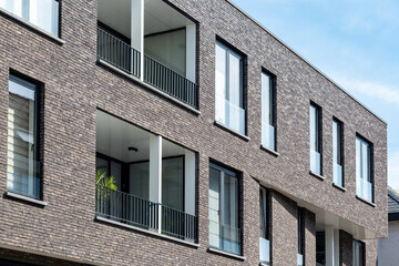 Modern Residential Building with Grey Brick Facade and Balconies,New Apartment Block Architecture with Minimalist Brickwork,Newly Built Apartment House in a Modern City District © Anna Kondratiuk