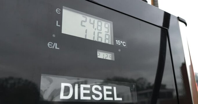 Pumping diesel fuel at a European gas station showing price and volume