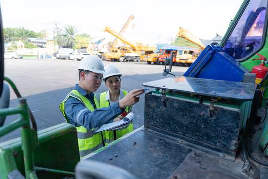 Engineers perform crane inspection and safety checks on a mobile crane compartment, reviewing equipment condition with a checklist to support maintenance and reliable operation.