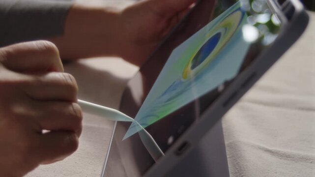 Close-up, the artist draws a picture on the screen of the tablet