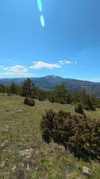Clear sky above rugged mountains, sunbeam glows. Ljukten peak, (Balkans, Serbia) Vertical