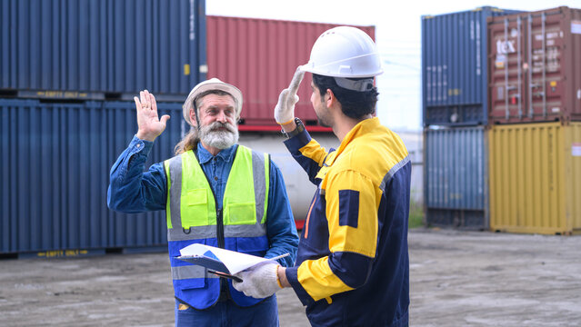 Two engineers celebrate project completion in a container yard