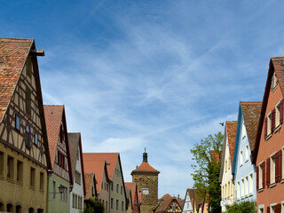 Fototapeta premium Medieval Old Town Street in Rothenburg ob der Tauber, Franconia, Bavaria, Germany. Historic buildings along cobblestone street. Tourism and culture.