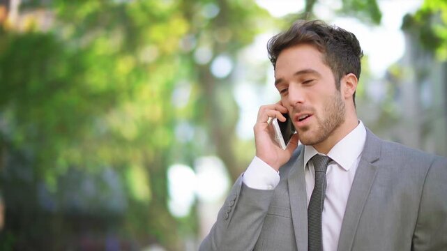 Businessman Speaking On Phone In Green Outdoor Setting, Combining Professional Communication With Nature, Representing Balance Between Work, Lifestyle, And Modern Connectivity.