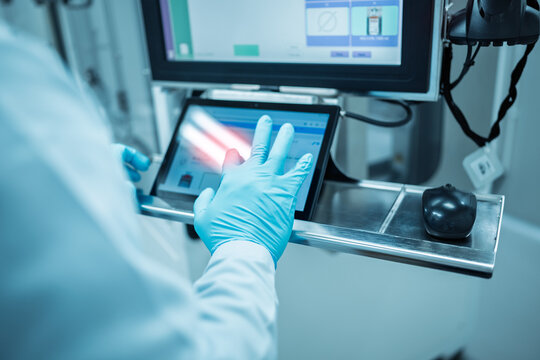 Man scientist using tablet computer in scientific office.Medical engineers work together on artificial intelligence data and analysis.Technician using computers production at electronics manufacture.