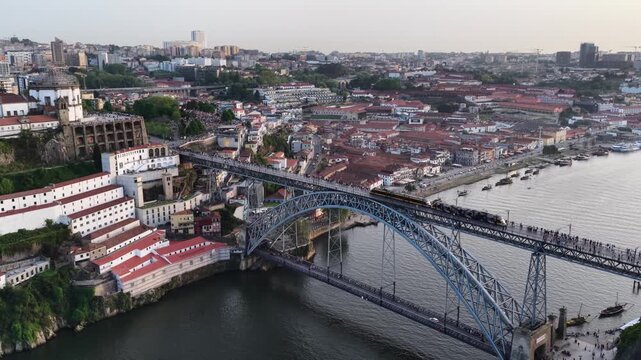 Train crossing Dom Luis I Bridge over Douro River in Porto