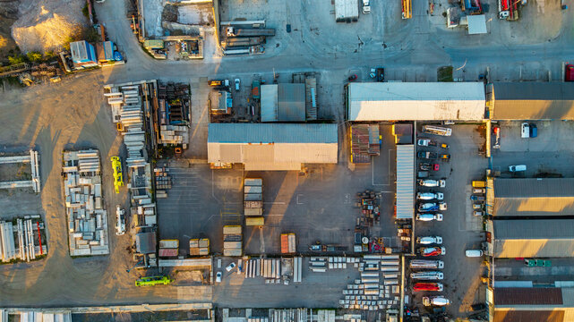 Aerial view of Malesice Infrastructure Objects with industrial warehouses, concrete mixers, and construction materials in Hlavni mesto Praha, Hlavni mesto Praha, Czechia.