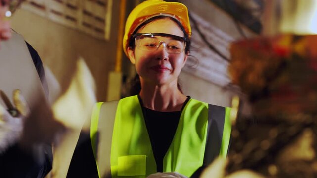 Construction worker safety helmet vest protective eyewear female industrial site, factory teamwork coordination and inspection, industrial safety engineer using tablet with machinery manufacturing