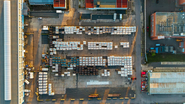Aerial view of Malesice Infrastructure Objects with rows of stacked pallets and industrial warehouses in Hlavni mesto Praha, Hlavni mesto Praha, Czechia.