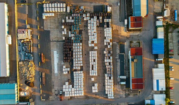 Aerial view of Malesice Infrastructure Objects with rows of stacked industrial pallets and containers in a logistics yard during sunset Hlavni mesto Praha, Hlavni mesto Praha, Czechia.