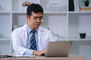 Fototapeta premium Medical professional working on laptop modern office digital health documentation focused environment professional viewpoint