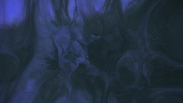 Close-up of cracked dry mud surface under blue ultraviolet lighting