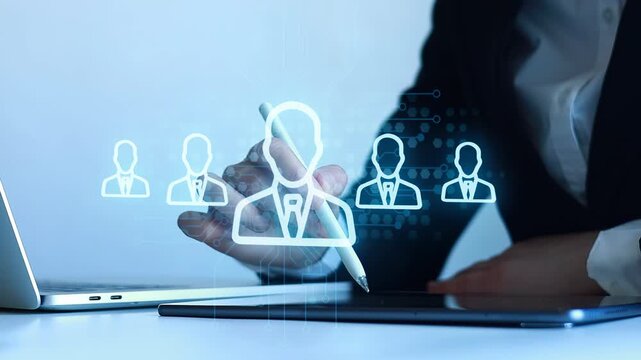 Business professional uses digital tablet to create user profiles in a modern office setting with a laptop nearby.