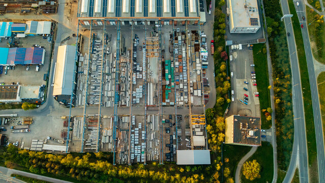 Aerial view of Malesice Infrastructure Objects featuring industrial warehouses outdoor storage yards with construction materials and gantry cranes Hlavni mesto Praha, Hlavni mesto Praha, Czechia.