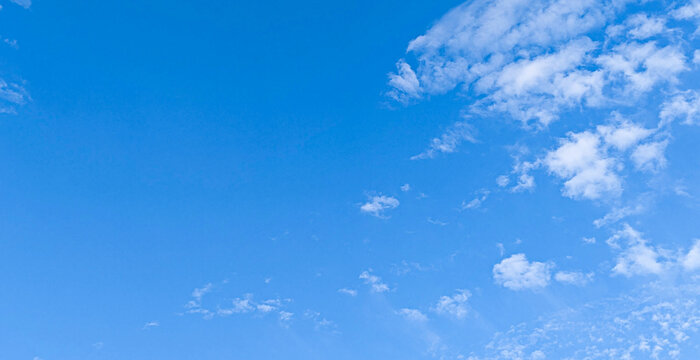 Vast blue sky with thin wispy white clouds during daytime.