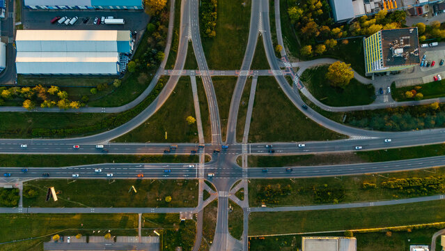 Aerial view of the Malesice Infrastructure Objects featuring a complex road intersection with cars, green spaces, and industrial buildings in Hlavni mesto Praha, Hlavni mesto Praha, Czechia.