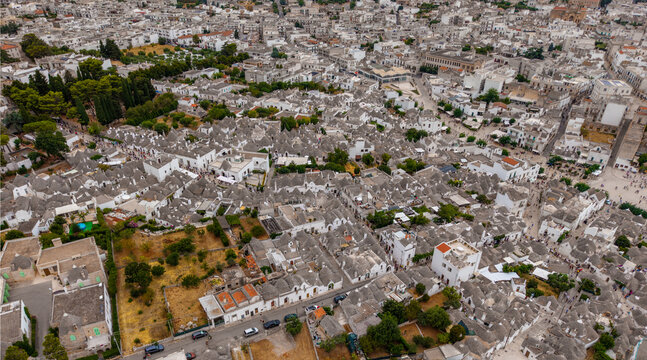 Aerial view of the historic Trulli houses with their iconic conical stone roofs and narrow streets in Alberobello, Apulia, Italy.