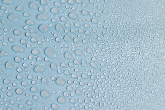 wet blue plastic material for wrapping bouquets, water droplets