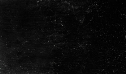 Obraz premium Vintage distressed texture on dark surface.dirty black texture background with dust overlay.Distressed wall texture for creative design.