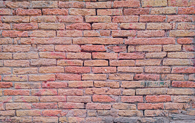 Fototapeta premium Red brick wall texture background with rustic aged masonry detail