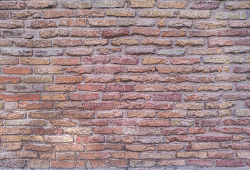 Fototapeta premium Red brick wall texture background with rustic aged masonry detail