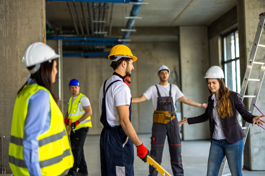 Emotional workplace conflict between a female manager and a builder on a construction site.
