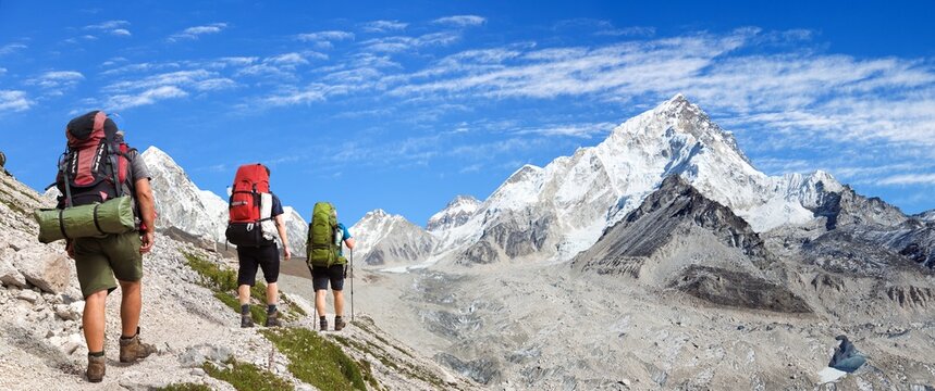 Three hikers mount Everest base camp Nepal Himalaya