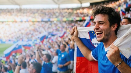 Fototapeta premium Slovenian football fan celebrating in stadium with national flag