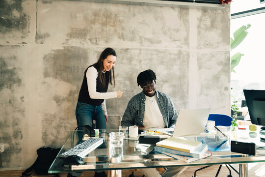 Happy colleagues working together at startup workspace