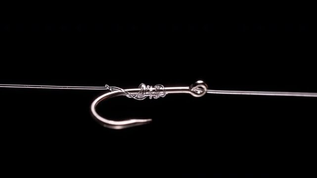 Fishing Hook with Transparent Line and Tightened Knot on Black Background, Macro Close Up with High Contrast Lighting, Slow Motion Secure Connection and Strength Under Tension