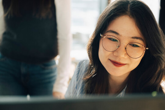 Smiling female business professional wearing eyeglasses at office