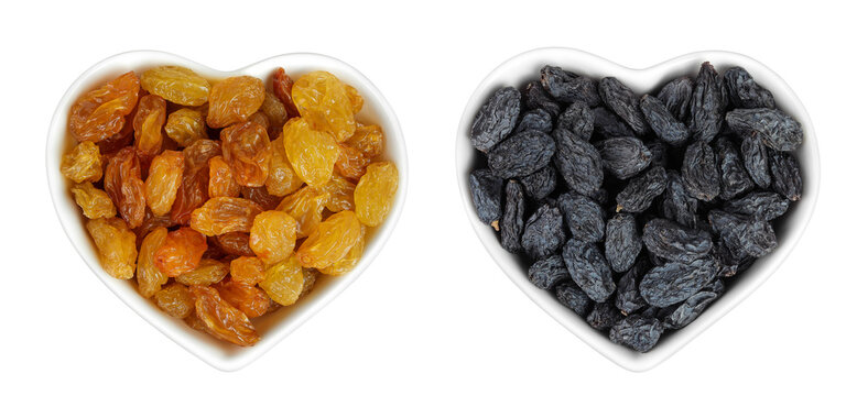 Yellow and black Raisins in ceramic bowl isolated on white background. Top view. Flat lay