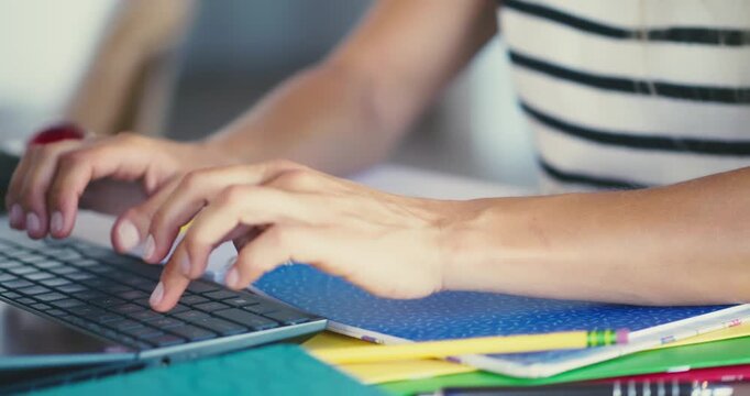 Person Typing on Laptop in Office Setting