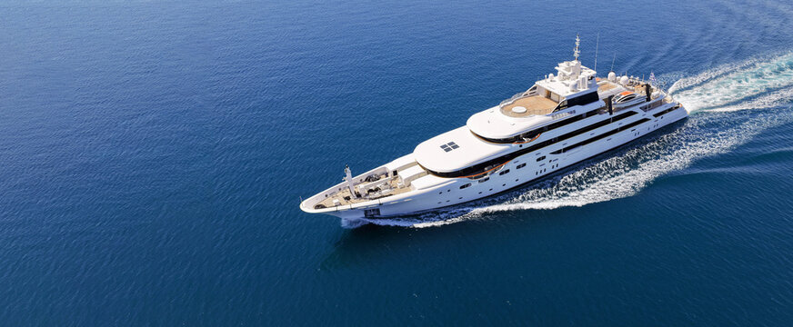 Aerial drone ultra wide panoramic photo with copy space of luxury yacht with wooden deck cruising near port Port Hercules in deep blue sea, Monaco, France