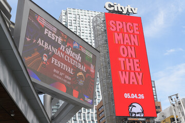 Fototapeta premium Citytv sign and narrow digital billboard featuring advertising for KFC fast food restaurants including community events announcements, Sankofa Square, Toronto