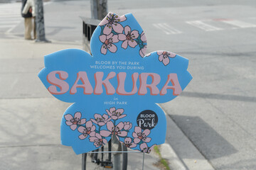 Naklejka premium Bloor on the Park BIA novelty welcome sign for Sakura or cherry blossom viewing at High Park, Toronto