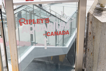 Naklejka premium Ripley's Aquarium of Canada sign on a glass staircase barrier panel located at 288 Bremner Blvd, Toronto