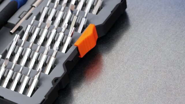 A set of metal bits for installation work in a plastic case.