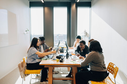 Group of diverse entrepreneurs working on project at their creative workspace