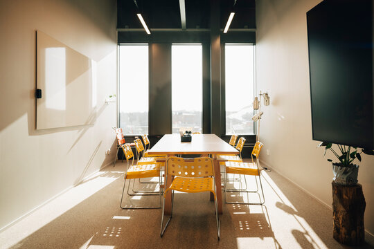 Empty office space with whiteboard and large TV screen